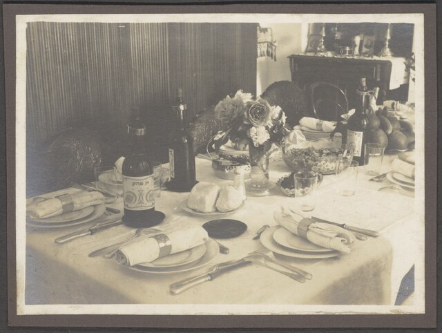 set dinner table with cutlery fruits bowl bottles and flowers nino f scholten photographic print 04 070