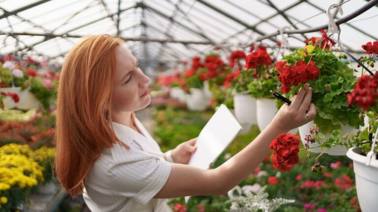 SePRO Corporation Ornamental section header image featuring a woman inspecting red flowers in a greenhouse