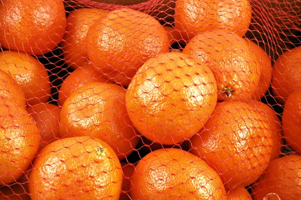 Clementines in a netted orange bag